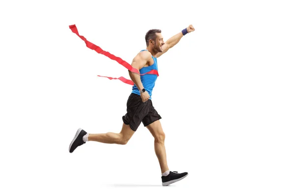 Manlig atlet på mållinjen i en ras gest lycka — Stockfoto