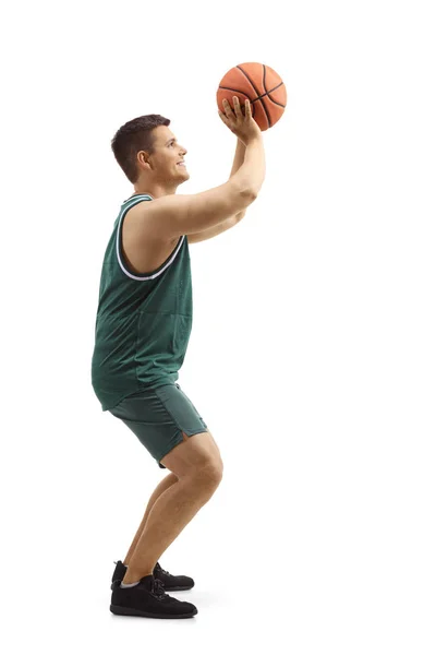 Hombre en una camiseta deportiva disparando con una pelota de baloncesto —  Fotos de Stock
