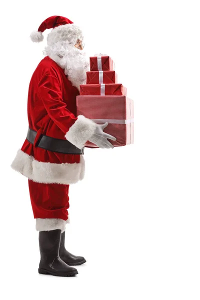 Санта Клаус держит кучу рождественских подарков — стоковое фото