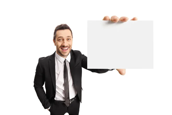 Cheerful young businessman holding a blank card — Stock Photo, Image