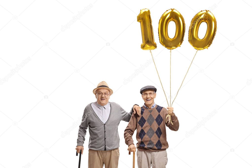 Two senior men with a golden number hundred balloon