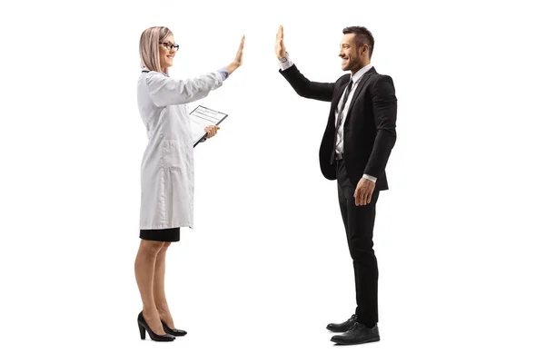 Young female doctor making high-five gesture with a businessman — Stock Photo, Image