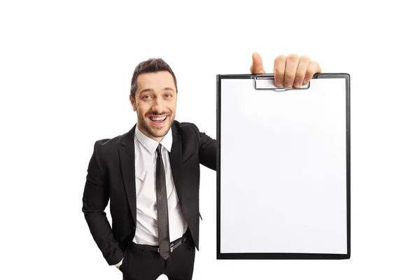 Joven hombre profesional en traje sonriendo y sosteniendo un portapapeles —  Fotos de Stock