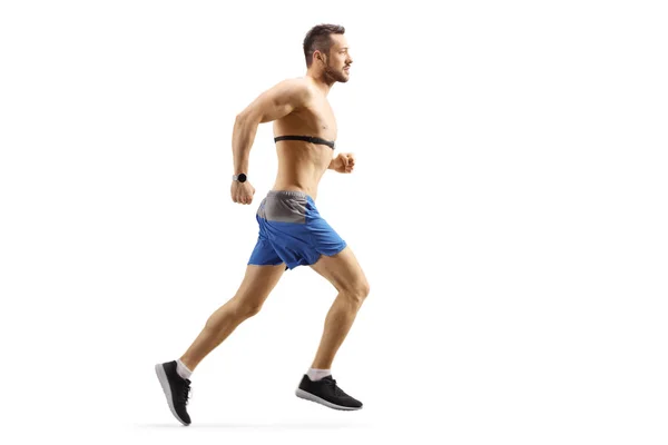 Young man running and wearing a chest strap monitor — Stock Photo, Image