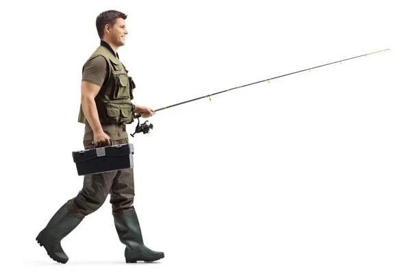 Fisherman with a fishing rod walking — Stock Photo, Image