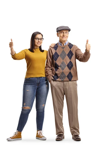 Abuelo y nieta de pie y mostrando los pulgares hacia arriba — Foto de Stock