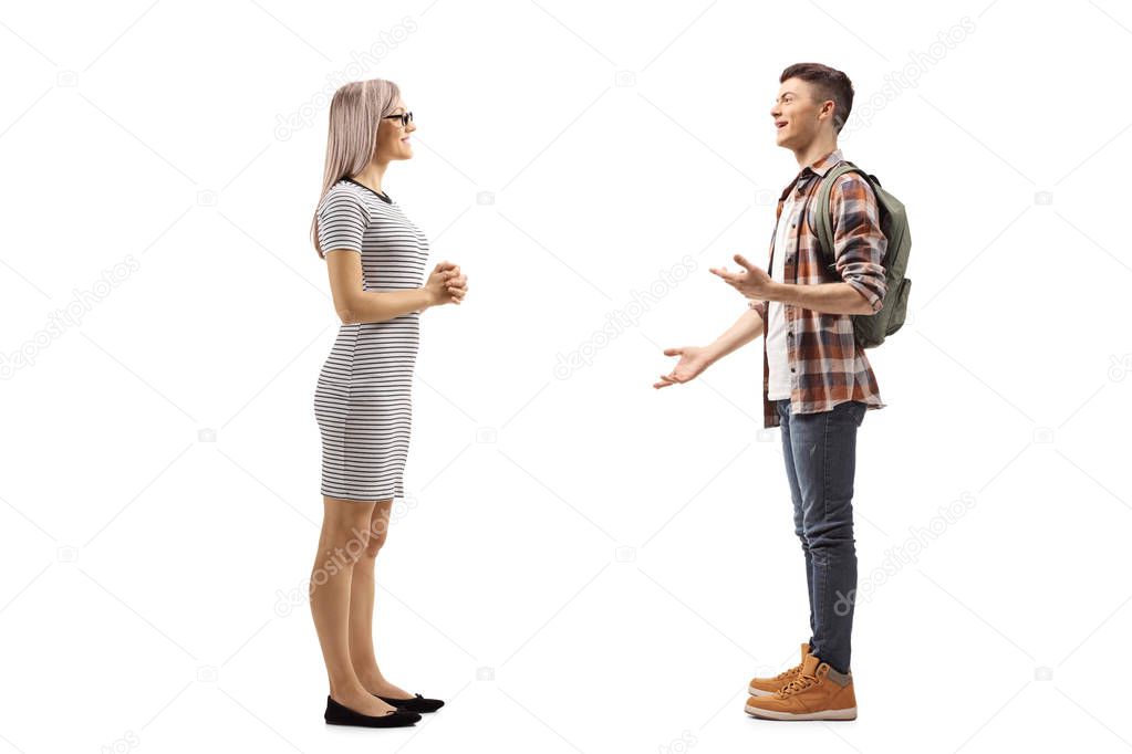 Young woman listening to a male student explaining and gesturing