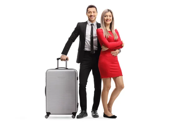 Happy elegant young couple with a suitcase — Stock Photo, Image