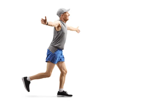 Senior man running and spreading arms — Stock Photo, Image