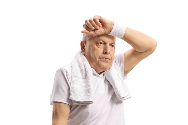 Exhausted senior on a holding arm on his forhead — Stock Photo, Image