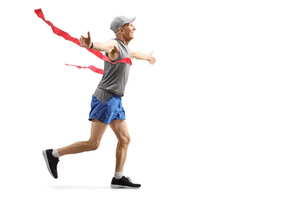 Senior male runner on the finish line — Stock Photo, Image