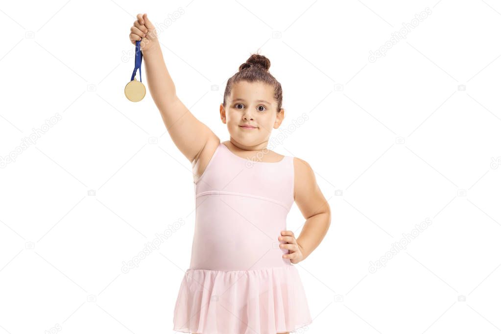 Little ballet dancer girl holding a gold medal 