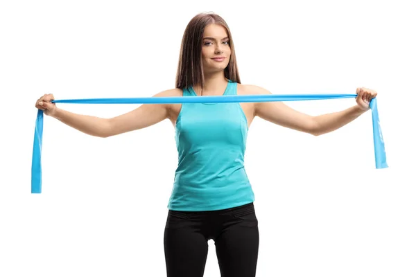 Beautiful young woman exercising with a rubber band — Stock Photo, Image