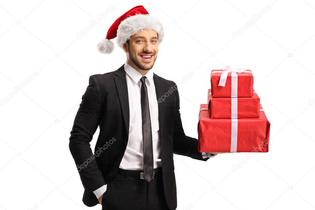 Businessman wearing santa claus hat and holding a pile of presen