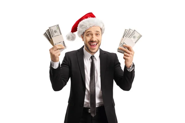 Glücklicher Mann in schwarzem Anzug und Weihnachtsmann-Hut, der Geld in der Hand hält — Stockfoto