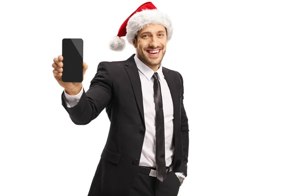 Uomo d'affari che indossa un cappello di Babbo Natale e che tiene un telefono cellulare — Foto Stock