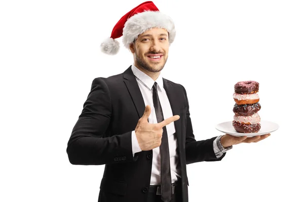 Empresario con un sombrero de Santa Claus sosteniendo un plato con chocolate — Foto de Stock