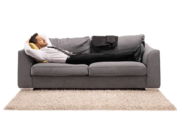 Man resting on a sofa after work — Stock Photo, Image