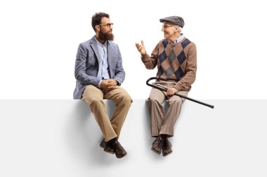 Bearded man and a senior sitting on a panel and talking 