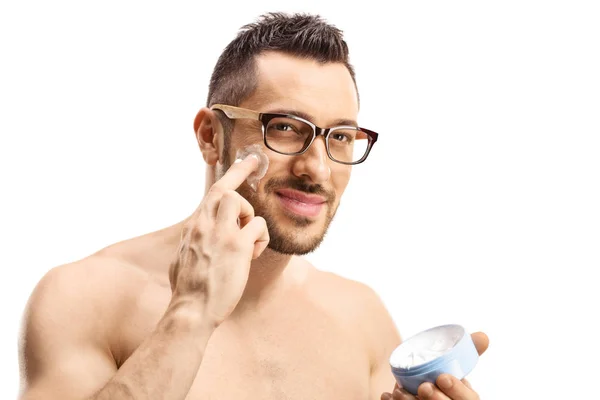 Portrait of a handsome man apllying face cream — Stockfoto