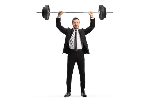 Man in a suit lifting weights and smiling — Stock Photo, Image