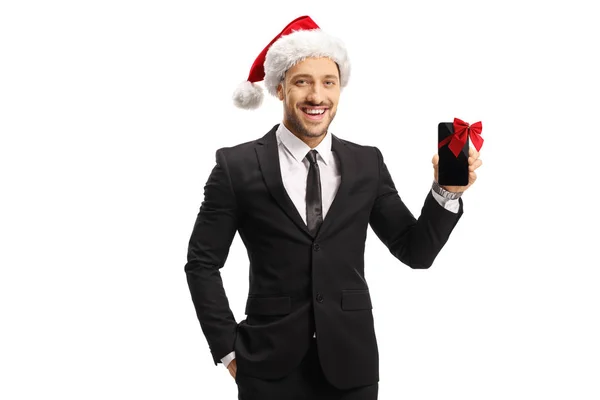 Uomo allegro in un abito e un cappello di Babbo Natale con un cellulare ph — Foto Stock