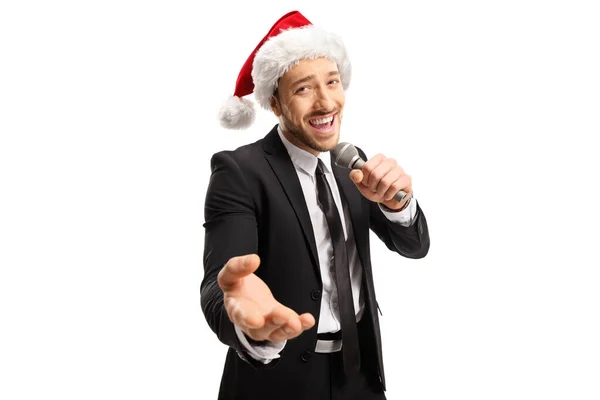 Handsome male singer in a black suit singing on a microphone and — Stock Photo, Image