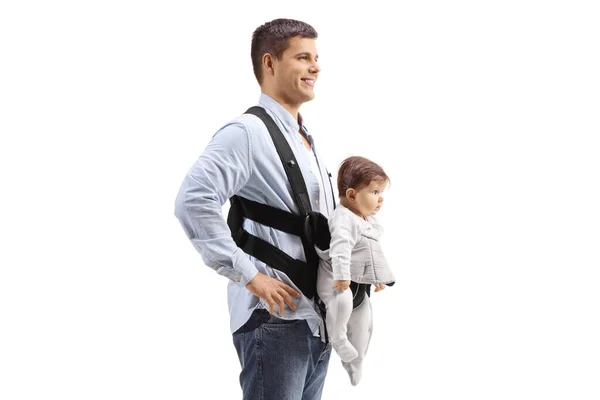 Father with a baby in a carrier standing and smiling — Stock Photo, Image