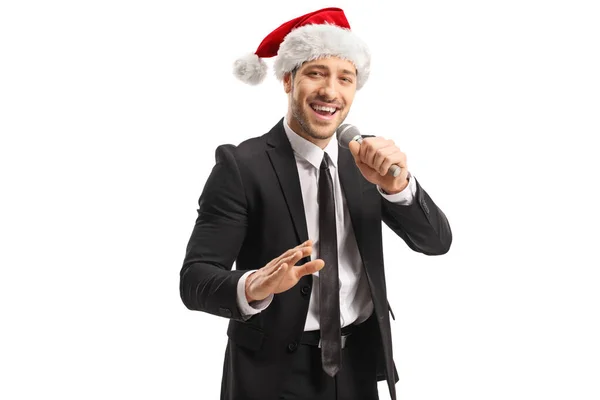 Mężczyzna piosenkarz w Santa Claus kapelusz śpiew na Boże Narodzenie — Zdjęcie stockowe