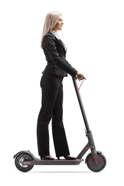 Woman in formal clothes riding an electric scooter to work — Stock Photo, Image