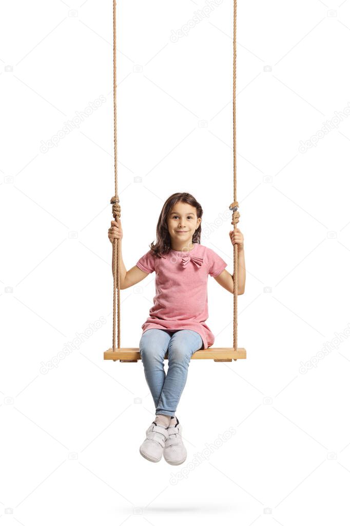 Happy little girl sitting on a wooden swing