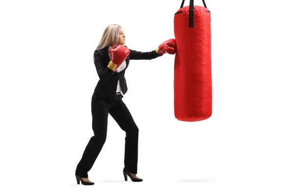 Genç iş kadını boks torbasını yumrukluyor. — Stok fotoğraf