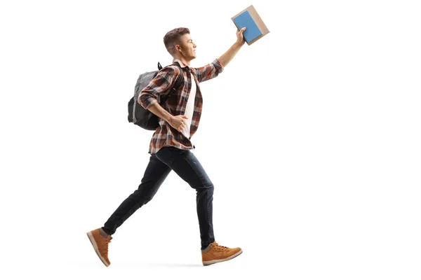 Estudante masculino correndo e segurando um livro — Fotografia de Stock