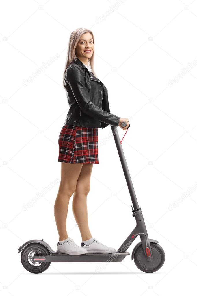 Beautiful young urban woman on an electric scooter