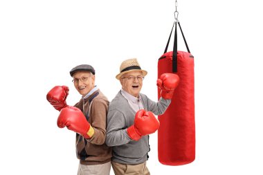 İki aktif kıdemli boks eldiveni ve kum torbası olan adam.