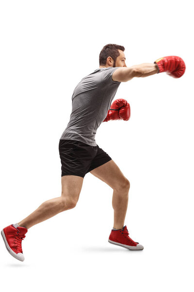 Young guy punching with boxing gloves