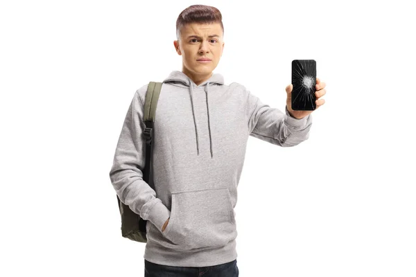 Trieste mannelijke tiener met een mobiele telefoon met een gebroken scherm — Stockfoto
