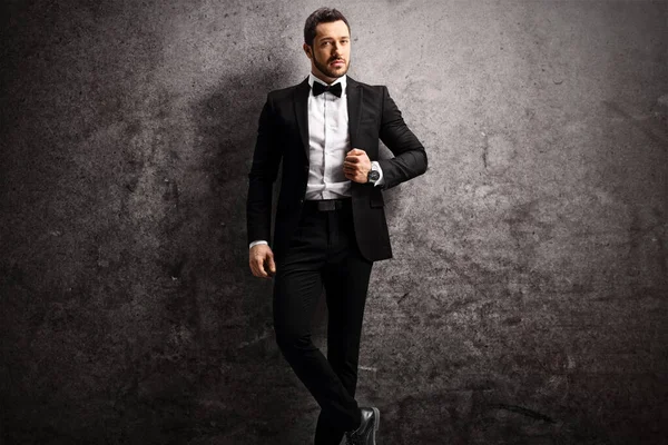 Young man in a black suit and bow tie — Stock Photo, Image