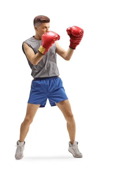 Jeune homme d'entraînement de boxe avec des gants rouges — Photo