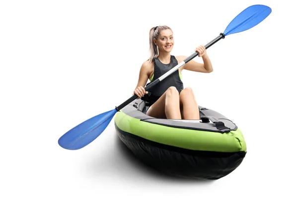 Young female in a canoe with paddles smiling — Stock Photo, Image