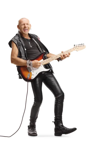 Male guitarist in leather clothes playing and singing — Stock Photo, Image