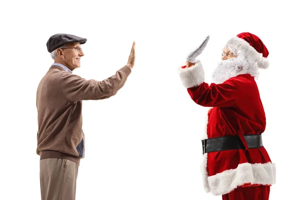 Homem sênior e Papai Noel fazendo gesto high-five — Fotografia de Stock