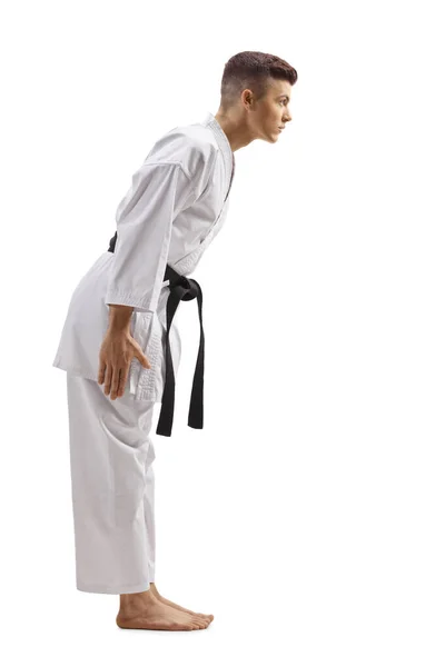 Young guy in karate kimono with black belt bowing — Stock Photo, Image