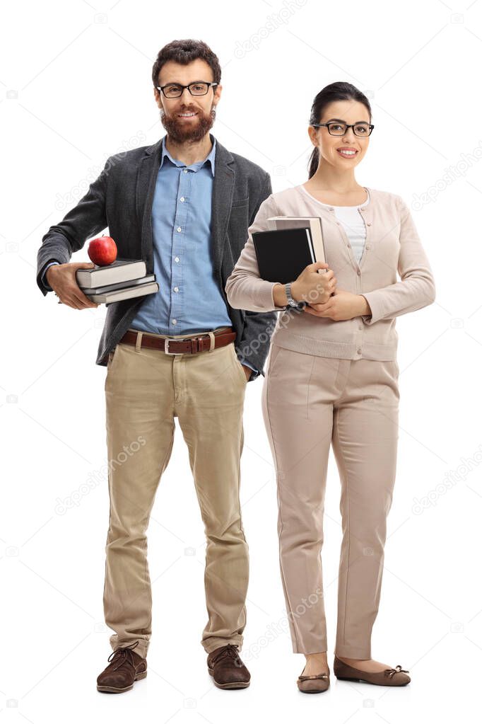 Male and female teachers standing and holding books