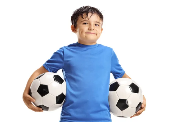 Niño sosteniendo dos bolas de fútbol — Foto de Stock