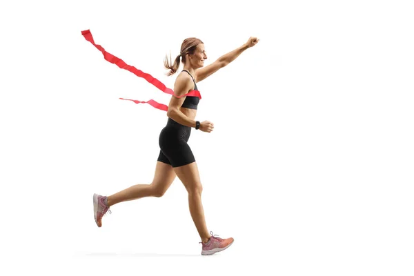 Bir maratonun bitiş çizgisinde koşan kadın koşucu — Stok fotoğraf