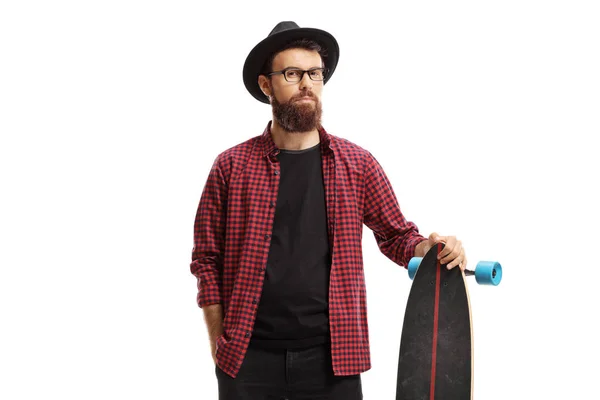 Männlicher Hipster steht und hält ein Longboard — Stockfoto