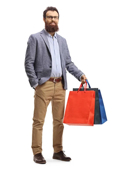 Vousatý muž držící nákupní tašky — Stock fotografie