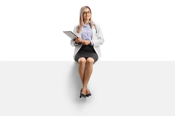 Full Length Portrait Female Doctor Sitting Blank Panel Isolated White — Stock Photo, Image