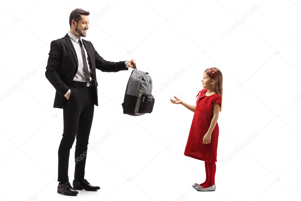 Full length shot of a father giving a backpack to a girl isolated on white background